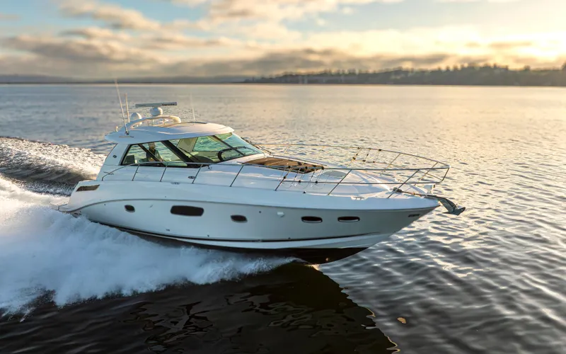  Yacht Photos Pics 2010 Sea Ray Sundancer yacht cruising on calm waters at sunset.