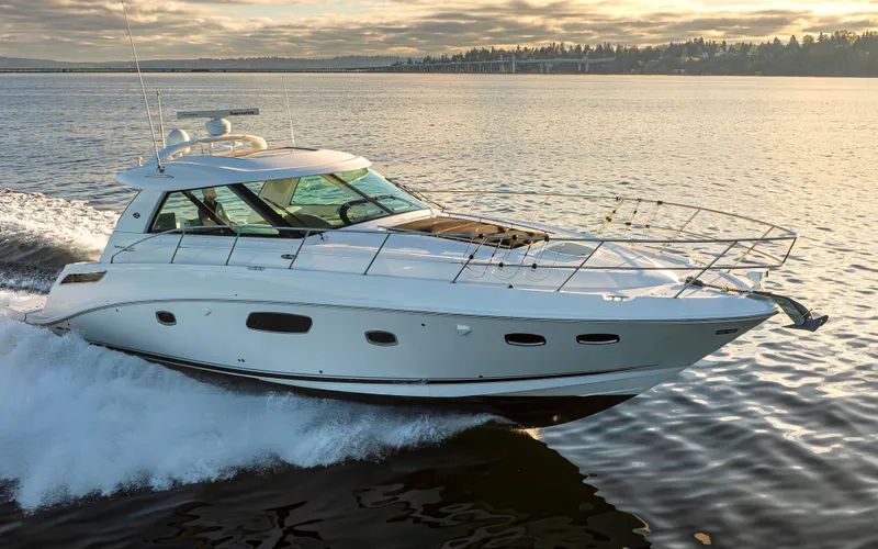  Yacht Photos Pics 2010 Sea Ray Sundancer yacht cruising on calm waters at sunset.