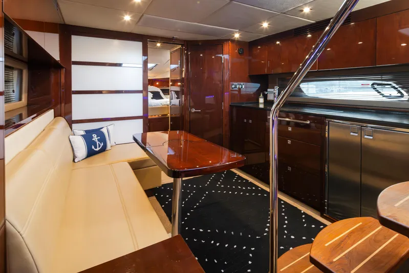  Yacht Photos Pics Luxurious interior of 2010 Sea Ray Sundancer yacht with elegant seating and modern kitchen.