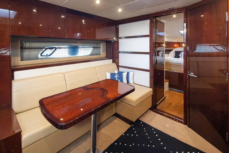  Yacht Photos Pics Luxurious interior of 2010 Sea Ray Sundancer yacht with elegant seating and wooden finishes.