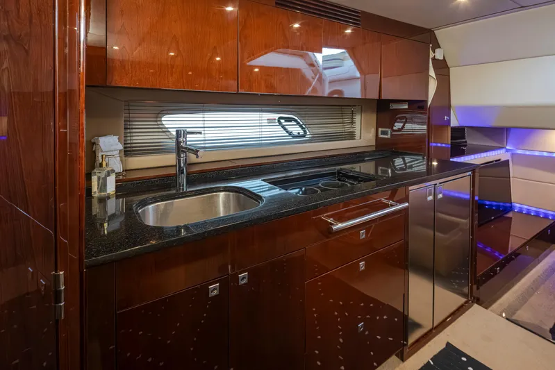  Yacht Photos Pics Luxurious 2010 Sea Ray Sundancer yacht kitchen with sleek wood cabinetry and modern appliances.