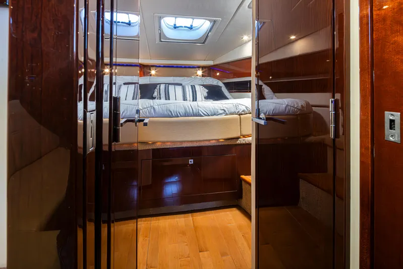  Yacht Photos Pics Luxurious 2010 Sea Ray Sundancer cabin interior with elegant wood finishes and cozy bedding.