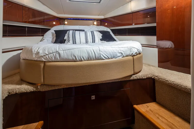  Yacht Photos Pics Luxurious 2010 Sea Ray Sundancer cabin interior with cozy bed and elegant wood finishes.