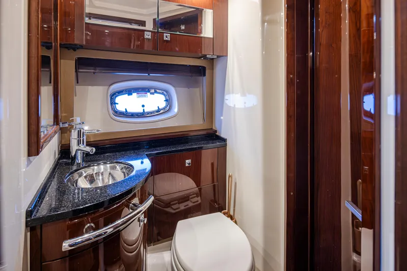  Yacht Photos Pics Luxurious bathroom in 2010 Sea Ray Sundancer yacht with sleek wood finishes and modern fixtures.