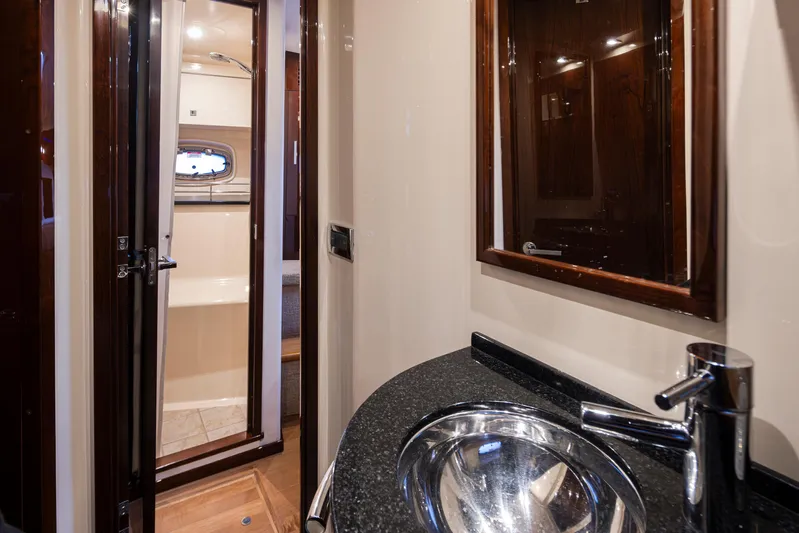  Yacht Photos Pics Luxurious bathroom interior of 2010 Sea Ray Sundancer yacht with modern sink and mirror.