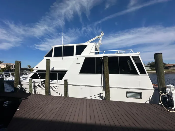 Bebe Yacht Photos Pics 1999 Viking 60 Cockpit Sports Yacht docked under clear blue sky.