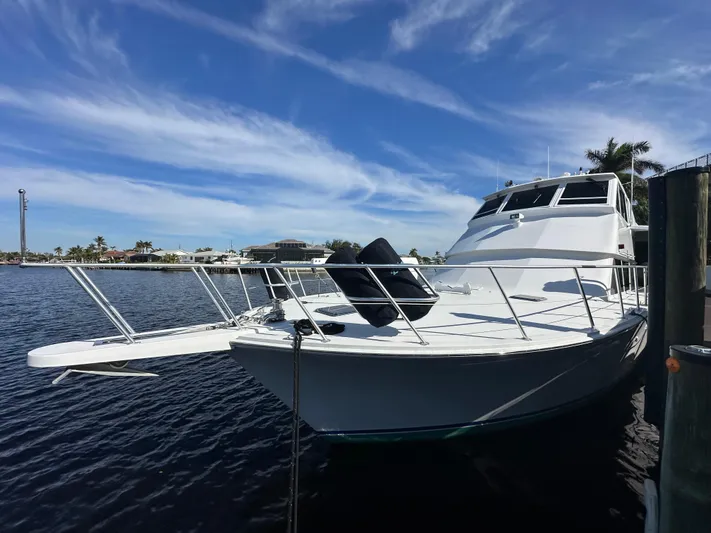 Bebe Yacht Photos Pics 1999 Viking 60 Cockpit Sports Yacht docked under a clear blue sky.