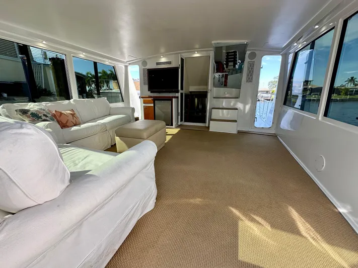 Bebe Yacht Photos Pics Spacious interior of 1999 Viking 60 Cockpit Sports Yacht with white sofas and large windows.