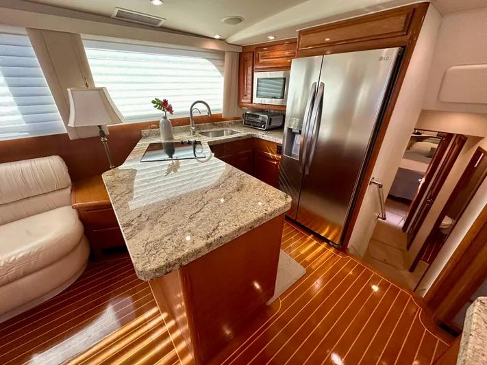 Bebe Yacht Photos Pics Luxurious kitchen interior of 1999 Viking 60 Cockpit Sports Yacht with granite countertops.