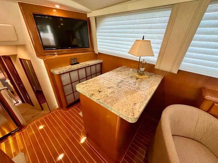 Bebe Yacht Photos Pics Luxurious interior of 1999 Viking 60 Cockpit Sports Yacht with granite countertop and elegant decor.