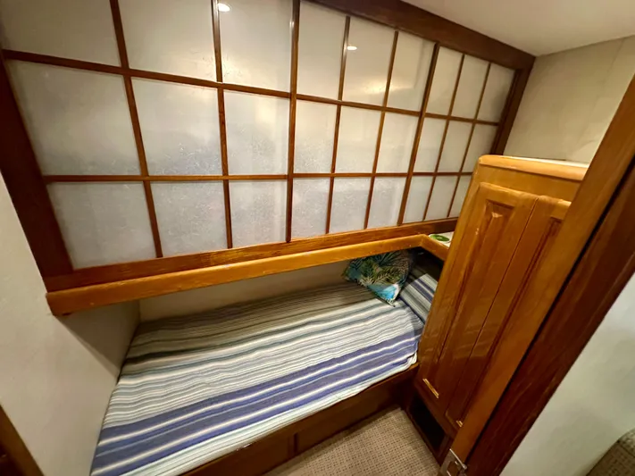 Bebe Yacht Photos Pics 1999 Viking 60 Cockpit Sports Yacht cabin with wooden accents and striped bedding.