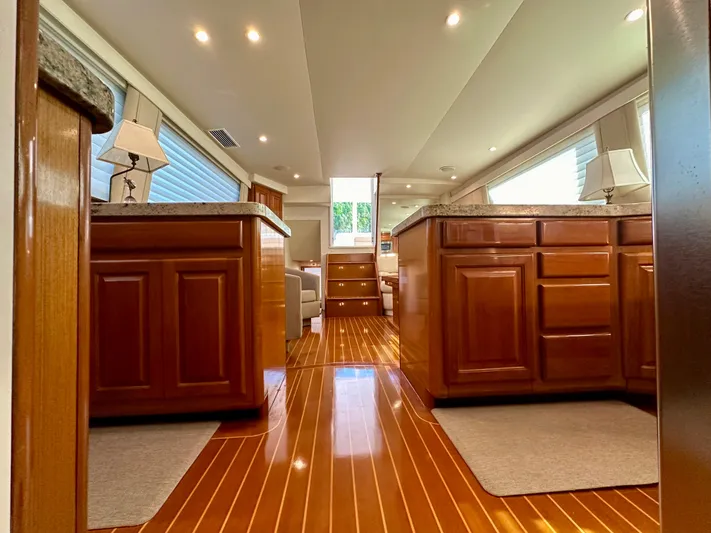 Bebe Yacht Photos Pics Luxurious interior of 1999 Viking 60 Cockpit Sports Yacht with polished wood and elegant cabinetry.