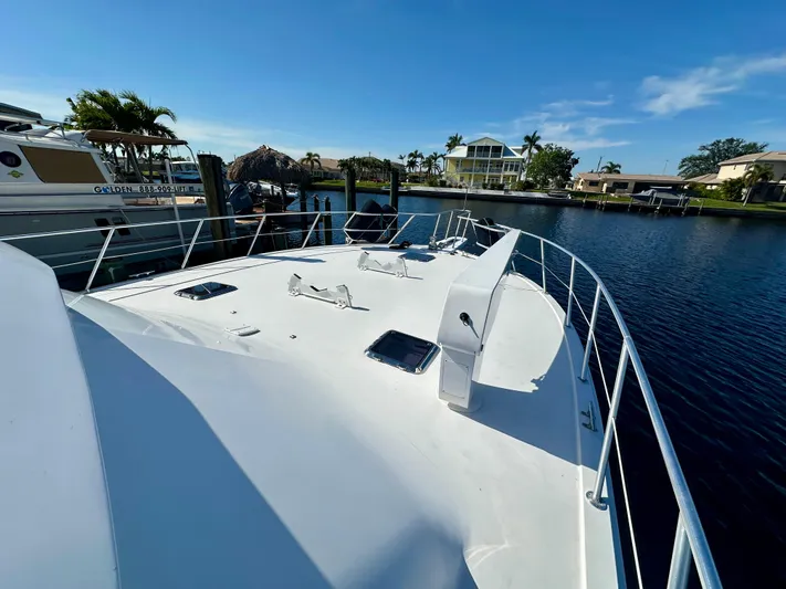 Bebe Yacht Photos Pics 1999 Viking 60 Cockpit Sports Yacht docked in a serene marina setting.