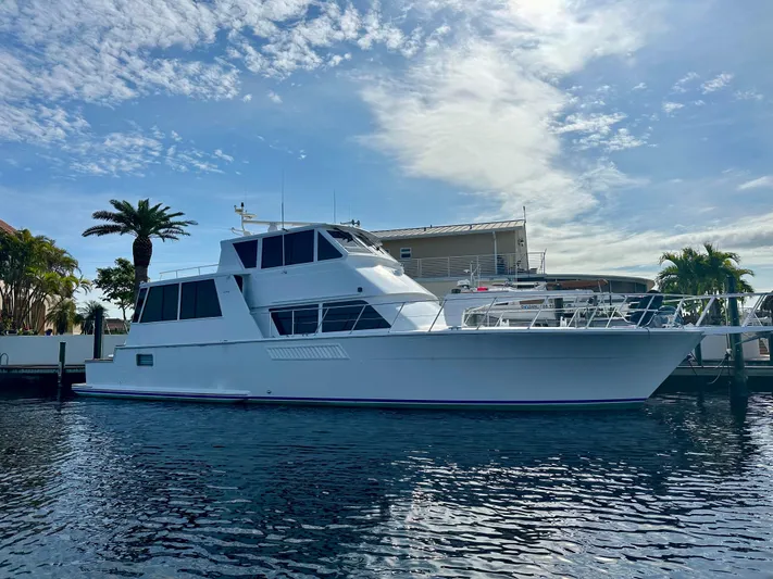 Bebe Yacht Photos Pics 1999 Viking 60 Cockpit Sports Yacht docked under a partly cloudy sky.