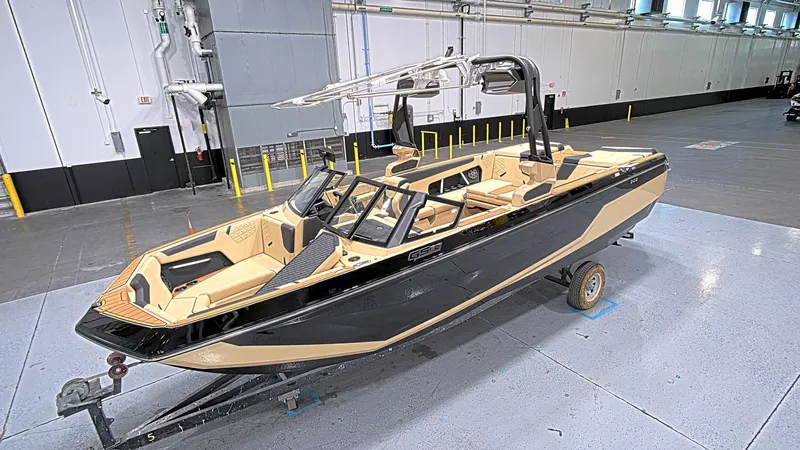  Yacht Photos Pics 2025 Nautique GS24 boat in a warehouse, featuring sleek design and modern amenities.
