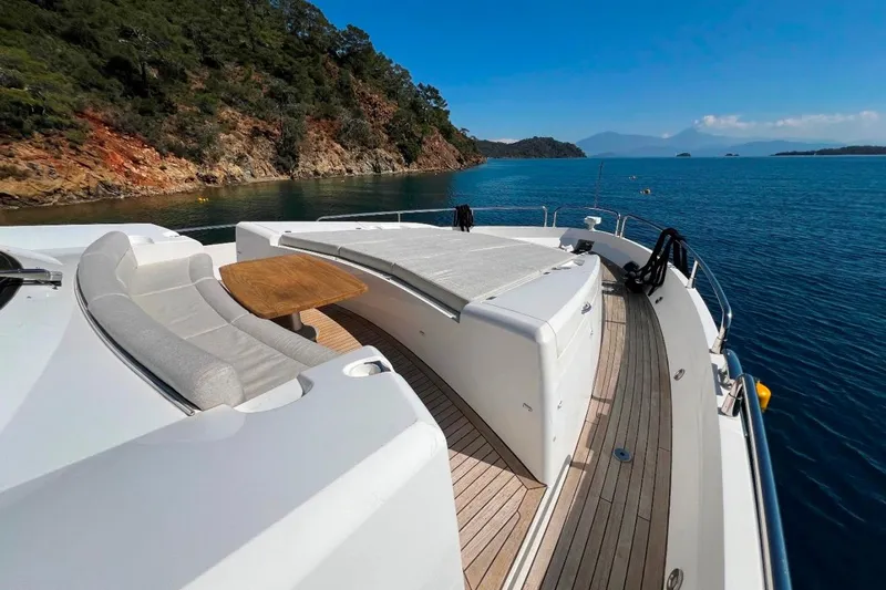  Yacht Photos Pics Luxurious 2011 Sunseeker 80 Yacht cruising near scenic coastline under clear blue skies.