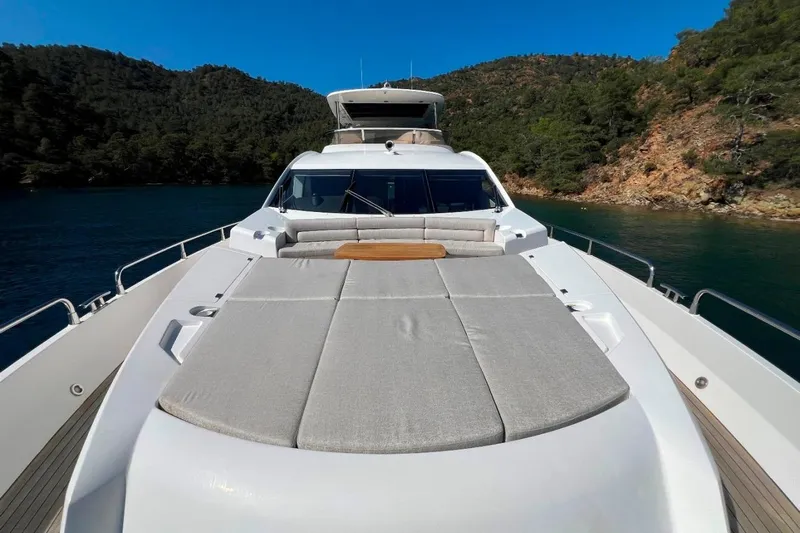  Yacht Photos Pics Luxurious 2011 Sunseeker 80 Yacht with spacious deck, surrounded by scenic waters and lush hills.