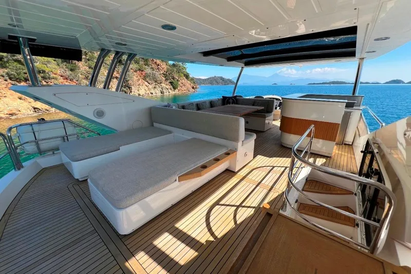 Yacht Photos Pics Luxurious 2011 Sunseeker 80 Yacht deck with seating, overlooking serene blue waters.