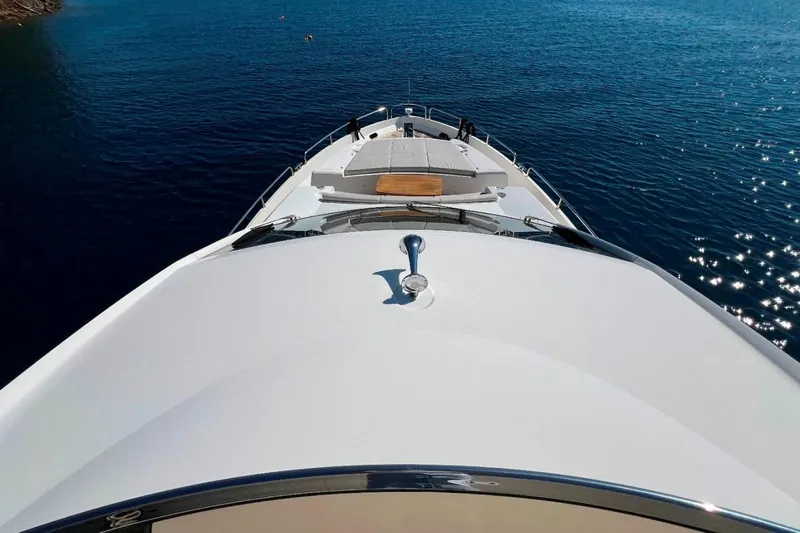  Yacht Photos Pics Sunseeker 80 Yacht 2011 cruising on clear blue water, top deck view.