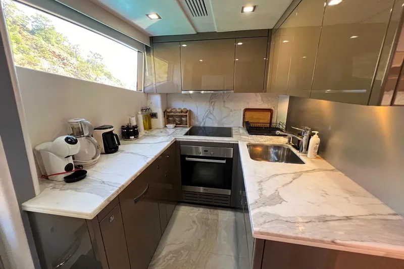  Yacht Photos Pics Modern kitchen interior on 2011 Sunseeker 80 Yacht with marble countertops and sleek cabinetry.