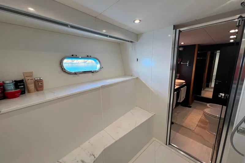  Yacht Photos Pics Luxurious bathroom interior of 2011 Sunseeker 80 Yacht with porthole and toiletries.