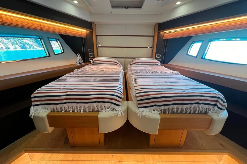  Yacht Photos Pics Luxurious twin bedroom on 2011 Sunseeker 80 Yacht with striped bedding and scenic windows.