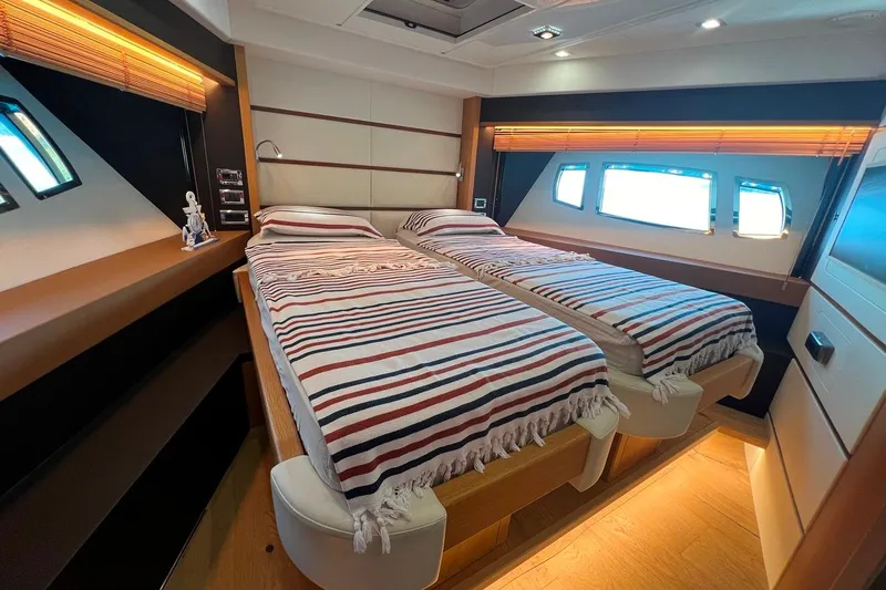 Yacht Photos Pics Luxurious 2011 Sunseeker 80 Yacht cabin with twin beds and striped bedding.