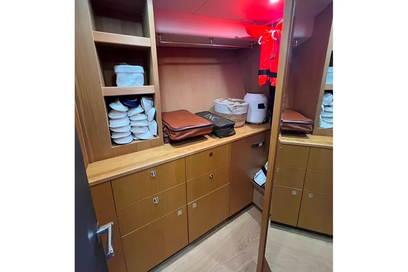  Yacht Photos Pics Luxurious wooden storage area inside a 2011 Sunseeker 80 Yacht, featuring shelves and cabinets.