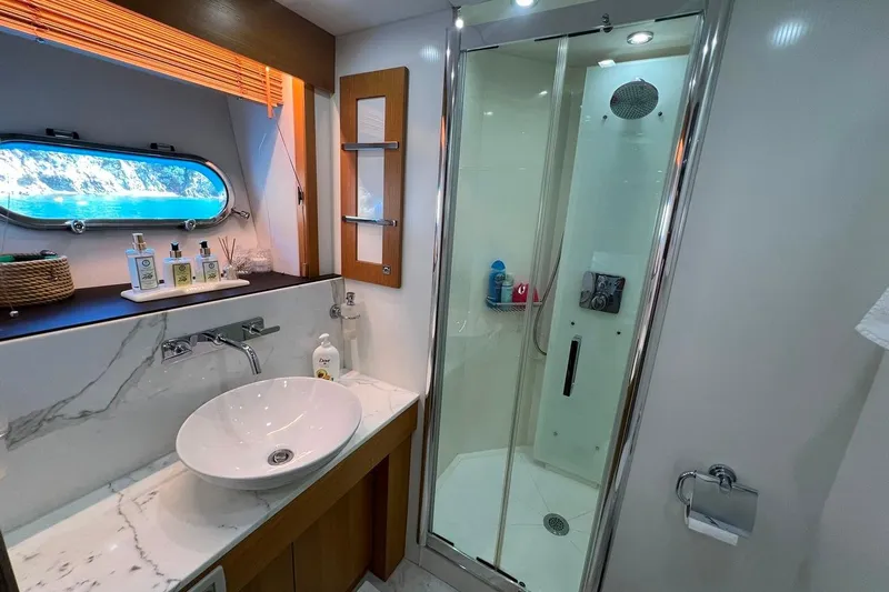  Yacht Photos Pics Luxurious bathroom on a 2011 Sunseeker 80 Yacht with modern fixtures and ocean view.