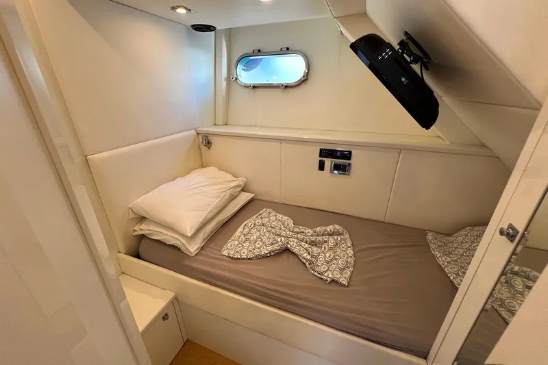  Yacht Photos Pics Compact cabin interior of 2011 Sunseeker 80 Yacht with bed and porthole window.