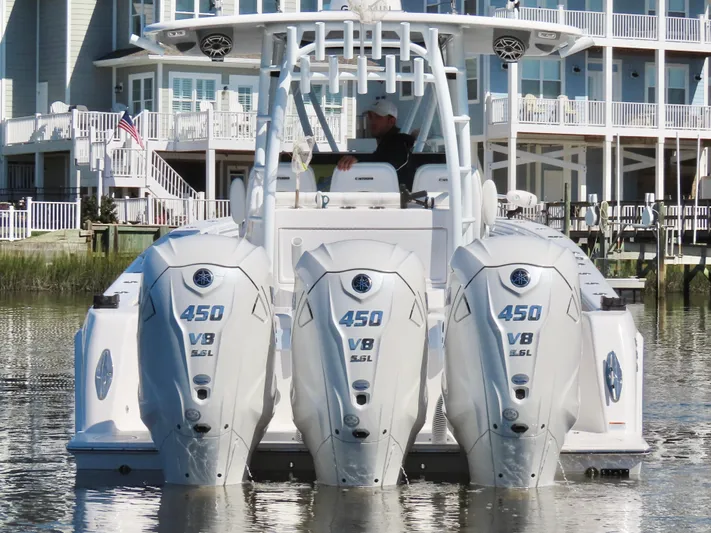  Yacht Photos Pics 2024 Contender 39ST boat with triple 450 V8 engines docked near waterfront homes.