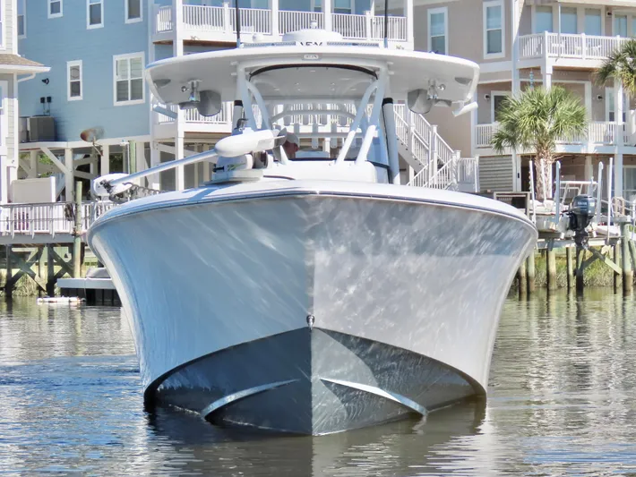  Yacht Photos Pics 2024 Contender 39ST boat docked in a residential marina setting.