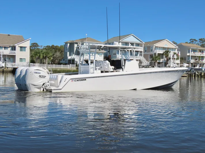  Yacht Photos Pics 2024 Contender 39ST boat on calm water near waterfront homes.