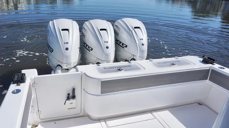  Yacht Photos Pics 2024 Contender 39ST boat with triple V8 outboard engines on calm water.