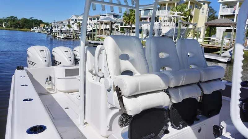  Yacht Photos Pics 2024 Contender 39ST boat with luxurious seating and powerful engines docked by waterfront homes.