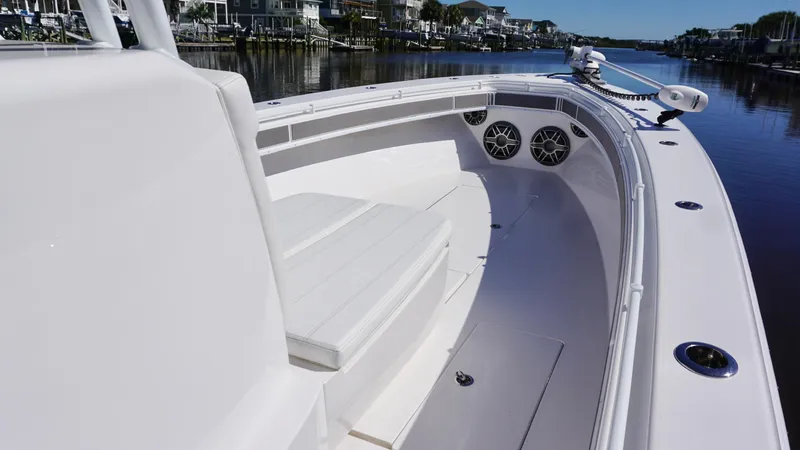  Yacht Photos Pics 2024 Contender 39ST boat interior with seating and speakers on a calm waterway.