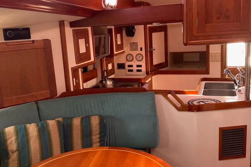 Tumblehome Yacht Photos Pics Interior of 1995 Little Harbor 51 Pilothouse yacht with cozy seating and kitchen area.