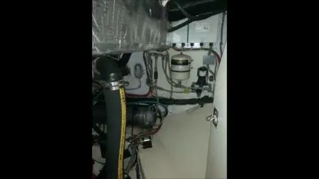 Tumblehome Yacht Photos Pics Engine room of 1995 Little Harbor 51 Pilothouse with visible hoses and wiring.