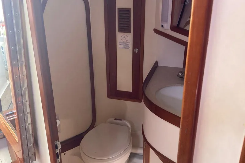 Tumblehome Yacht Photos Pics Bathroom interior of 1995 Little Harbor 51 Pilothouse yacht, featuring toilet and sink.