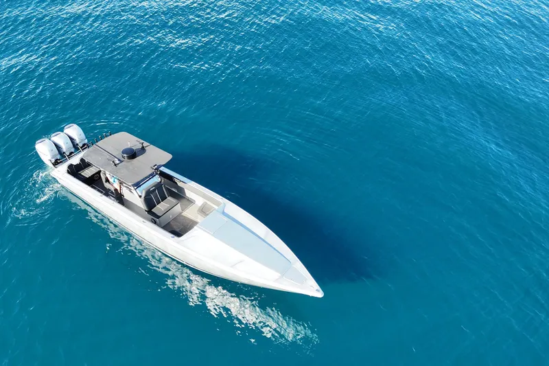  Yacht Photos Pics Aerial view of 2006 Lazer 40 boat cruising on clear blue water.