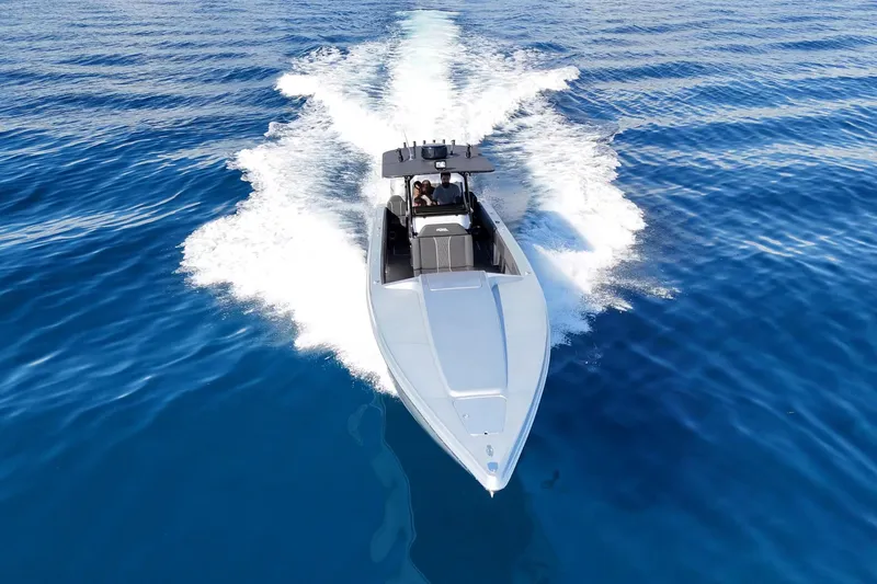  Yacht Photos Pics 2006 Lazer 40 speedboat cruising on clear blue ocean waters.