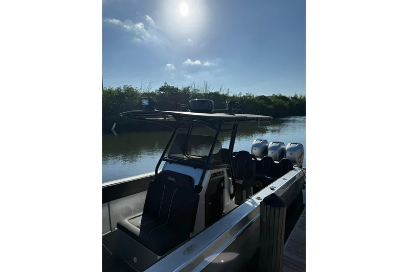  Yacht Photos Pics 2006 Lazer 40 boat docked on a sunny day, featuring multiple outboard engines.