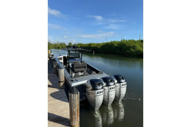  Yacht Photos Pics 2006 Lazer 40 boat with triple 350 horsepower engines docked on a sunny day.