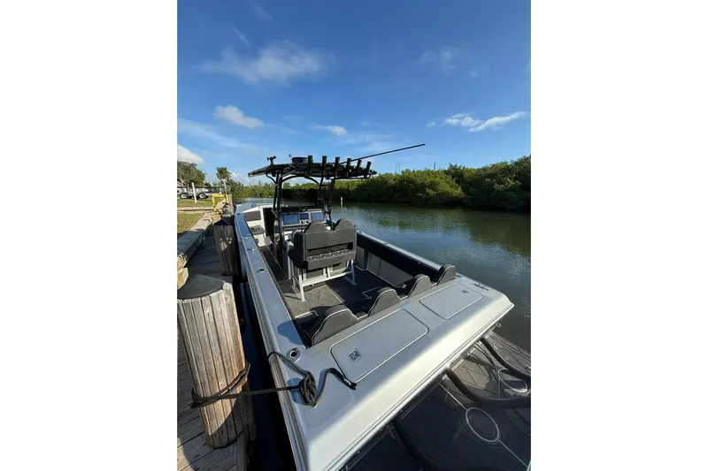  Yacht Photos Pics 2006 Lazer 40 boat docked by a serene river under a clear blue sky.