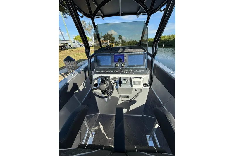 Yacht Photos Pics Helm of 2006 Lazer 40 boat with modern navigation equipment and steering wheel.