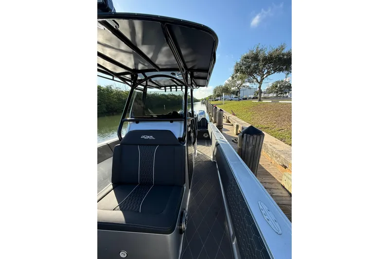  Yacht Photos Pics 2006 Lazer 40 boat docked by a canal under a clear blue sky.