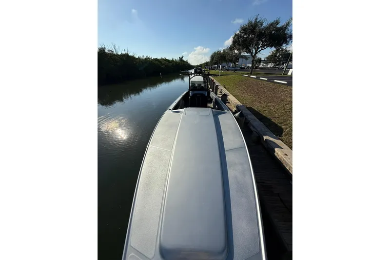  Yacht Photos Pics 2006 Lazer 40 boat docked by a calm river under a clear blue sky.