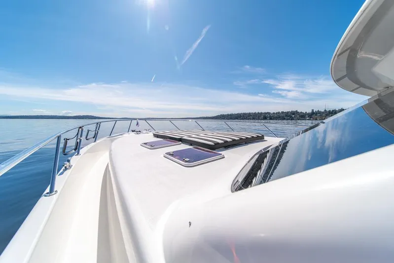 Escape Yacht Photos Pics 2013 Maritimo M58 yacht deck under clear blue sky on calm water.