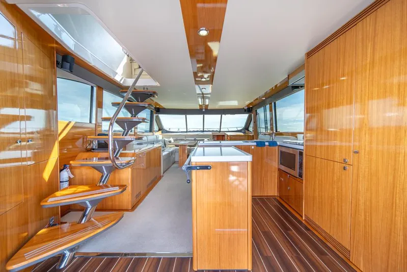 Escape Yacht Photos Pics Luxurious interior of 2013 Maritimo M58 yacht with wooden finishes and modern kitchen.