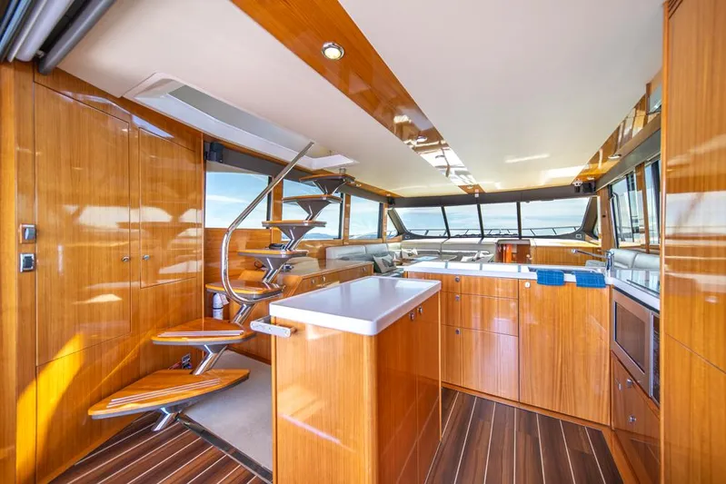 Escape Yacht Photos Pics Luxurious interior of 2013 Maritimo M58 yacht with wooden finishes and modern design.